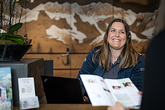 Gstaad Saanenland Tourism employee advises customers.