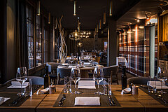 Noble restaurant with laid tables and various decorations.